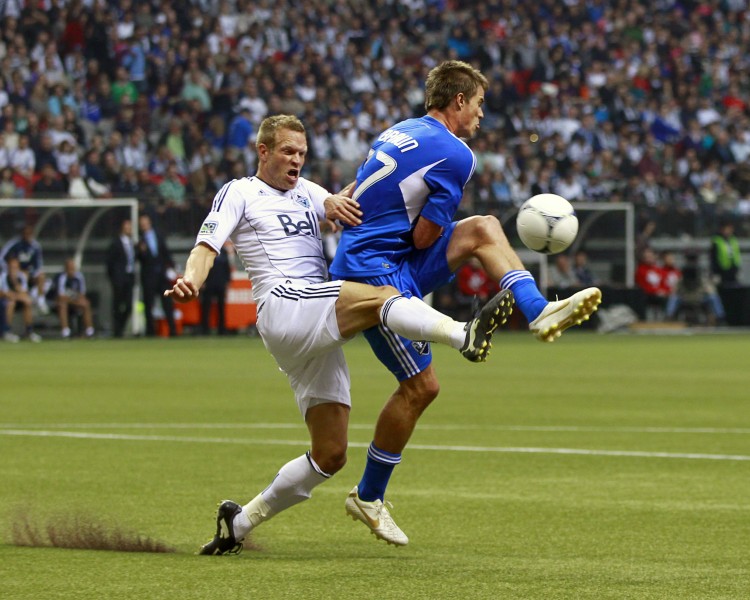 Vancouver's Jay DeMerit (L) challenges Montreal's Justin Braun for the ball in MLS First Kick action Saturday at B.C. Place Stadium. (Jeff Vinnick/Getty Images)