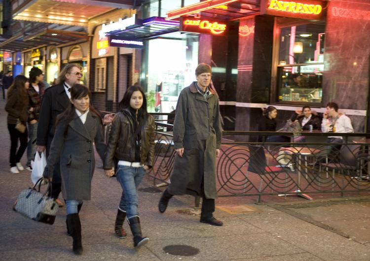 Pedestrians walk past restaurants on Granville Street in downtown Vancouver, British Columbia, on Feb. 7, 2009. When the harmonized sales tax take effect in B.C. on July 1, 2010, customers will pay 12 percent HST on restaurant meals rather than the 5 perc (Don Emmert/AFP/Getty Images)
