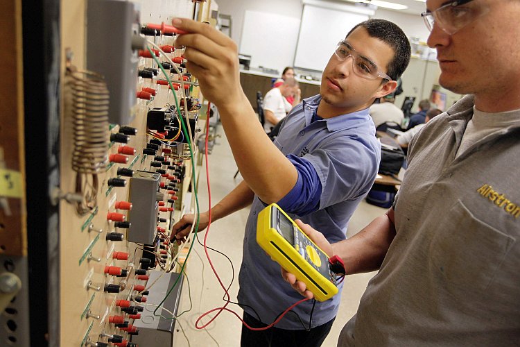 Bryant Batres (L) and Adam Friday (R) continue their education on servicing air conditioners