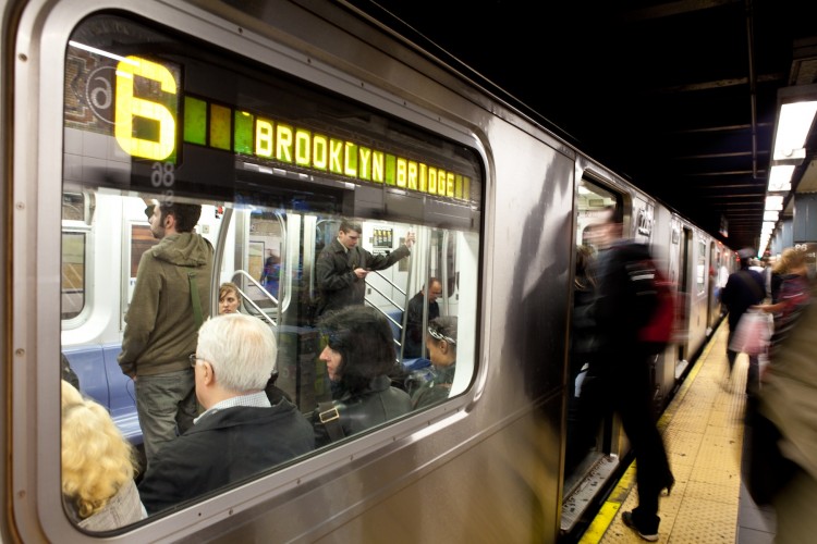 Commuters getting on and off the No. 6 Line subway train at the 86th Street station in Manhattan in this file photo. (Amal Chen/The Epoch Times)