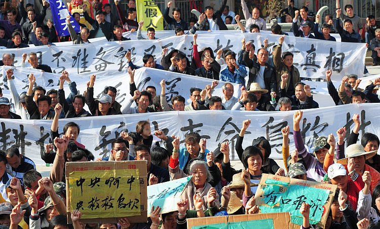 Villagers hold banners during a protest rally in Wukan