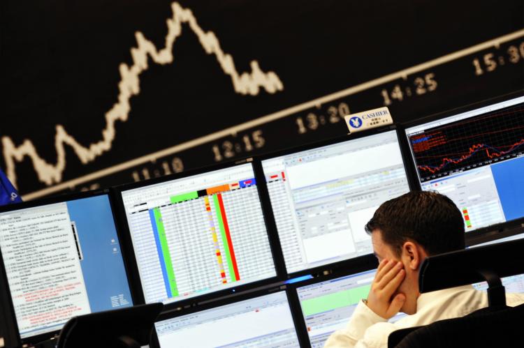 A stockbroker looks at his screens at Frankfurt's stock exchange last week. Experts fear that the U.S. credit crisis may hit European banks in the near future.  ((Thomas Lohnes/AFP/Getty Images))