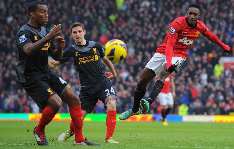 Manchester United striker Danny Welbeck shoots past two Liverpool defenders in his team's victory at Old Trafford in Manchester on Sunday, Jan. 13, 2013. (Andrew Yates/AFP/Getty Images) 