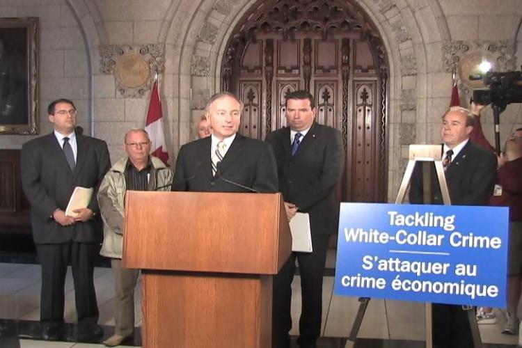 FIGHTING FRAUD: Minister of Justice and Attorney General of Canada Rob Nicholson speaking to the press on Parliament Hill Sept. 15 about the government's intention to introduce legislation to combat white-collar crime. To his right is Minister of Public W (NTDTV)