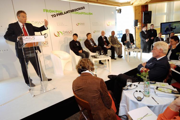 Former British Prime Minister Tony Blair speaks as former US President Bill Clinton (R) listens in Davos on January 29, 2009 during the Davos Philanthropic Roundtable. Other participants present are Chinese movie star Jet Li, Bill Gates, Bangladeshi banker and 2006 Nobel peace prize laureate Muhammad Yunus and Richard Branson. More than 2500 heads of states and government, ministers, captains of industry and leaders of churches and pressure groups were also present at the World Economic Forum. (Fabrice Coffrini/AFP/Getty Images)