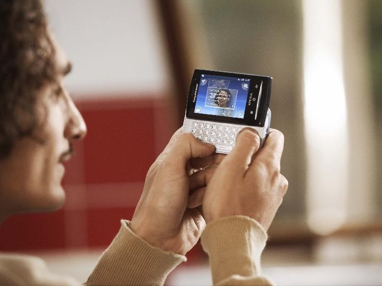 SMALL ANDROID: A man uses the QWERTY keyboard of a Sony Ericsson Xperia X10 Mini, which is one of the smallest Android smartphones available. (SONY)