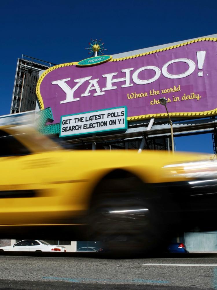 TAKEOVER TARGET? A taxicab drives by a Yahoo billboard in San Francisco, Calif. Yahoo is involved in speculation that the company may be a target for corporate takeover.  (Justin Sullivan/Getty Images)