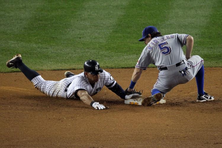 GETTING IT DONE: A-Rod beats Ian Kinsler's tag to steal second base. (Nick Laham/Getty Images)