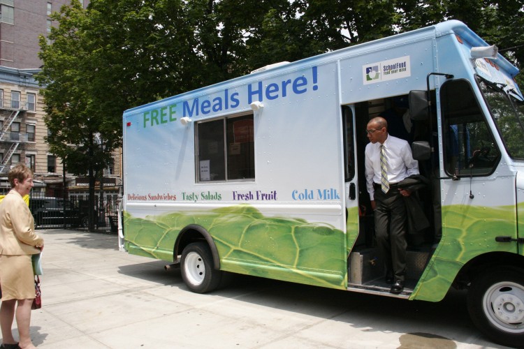 FREE MEALS: Schools Chancellor Dennis Walcott walks out of a free-meal truck operated by the Department of Education at P.S. 20 in Chinatown. Over 100 sites across the city will offer free meals to children during the the summer vacation.  (Gidon Belmaker/The Epoch Times)