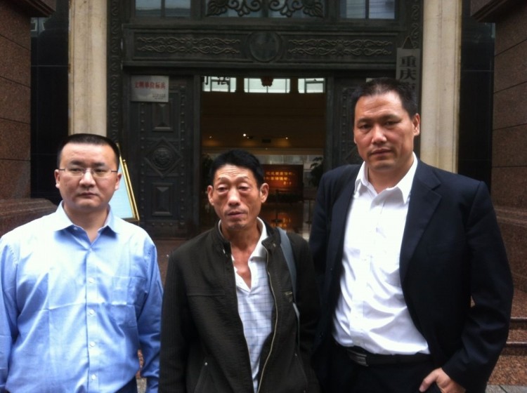 Ren Jianyu's father, Ren Shiliu (C), and defense lawyer Pu Zhiqiang (R). Oct. 10, 2012. Ren Jianyu, a low-level Chongqing official, was given a two-year labor camp sentence in August last year when Bo Xilai was still Party chief in the city. Ren was accused of 