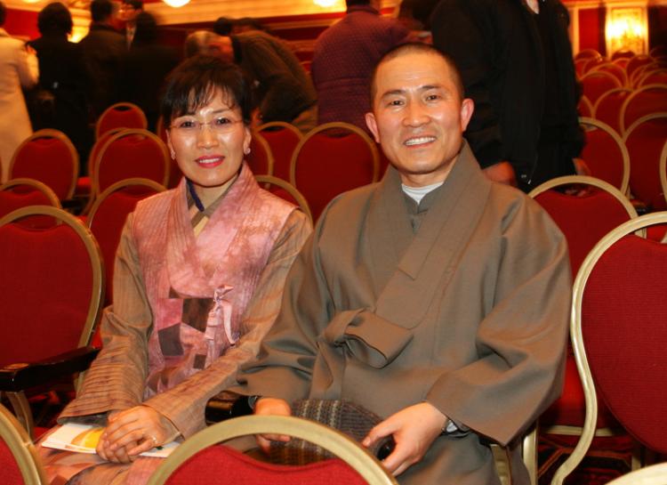 Abbot Eung-Cheon (R) of Seoul Land Temple  next to another audience member at the Divine Performing Arts show.  (Jin-Tae Kim/The Epoch Times)