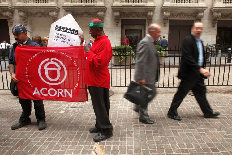 Businessmen walk by members of the activist housing group ACORN protest in front of Wall St.on June 16, 2009 in New York City. The House of Representatives on Thursday voted to eliminate federal funding of ACORN. (Spencer Platt/Getty Images)