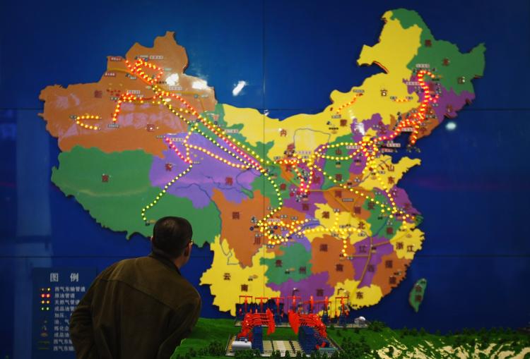 A Chinese visitor watches the map of the Chinese petroleum pipeline on March 21 in Beijing, China. Part of the distrust toward China involves territorial disputes with India to the west and Russia to the north.  (Feng Li/Getty Images)