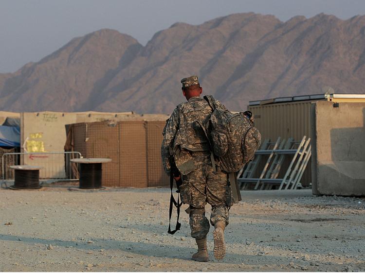 An American soldier walks with his equipment October 27, 2009 at Forward Operating Base Wilson in Kandahar Province, Afghanistan. (Chris Hondros/Getty Images)