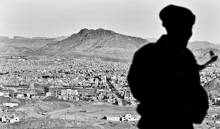 ON GUARD: A Yemeni soldier stands atop a hill overlooking the capital Sana'a on Jan. 13, 2010. Yemeni security forces killed alleged al-Qaeda leader Abdullah al-Mehdar Had on Tuesday night. (Ahmad Gharabli/AFP/Getty Images)