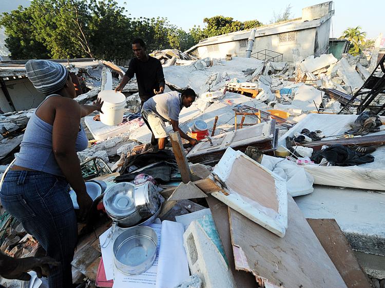 Haitian earthquake survivors search for useable items under the rubble of a collapsed chapel in Port-au-Prince. (Jewel Samad/AFP/Getty Images)