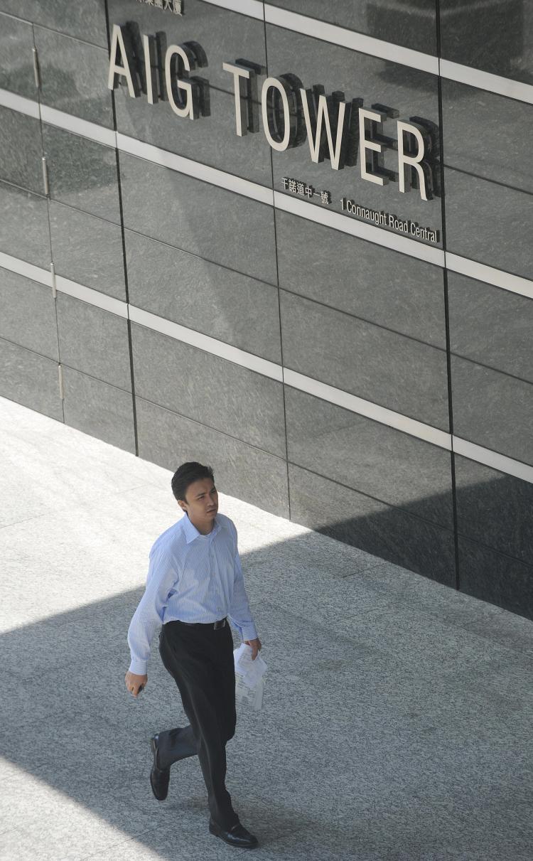 A man walks past AIG Tower in Hong Kong. On Thursday, Sen. Chris Dodd (D-CT) proposed his Restoring American Financial Stability bill to 'create a sound foundation to grow the economy and create jobs.' (Mike Clarke/AFP/Getty Images)