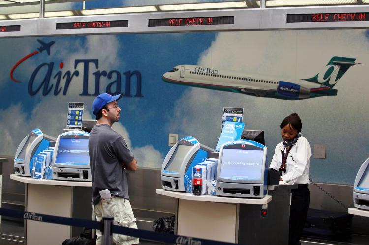 Photo Caption(s) & Photo Location(s) RISING PRICES: A customer checks in at the AirTran counter at the Fort Lauderdale-Hollywood International Airport last September in Fort Lauderdale, Fla. Prices for traveling have been increasing, according to the U.S. (Joe Raedle/Getty Images)