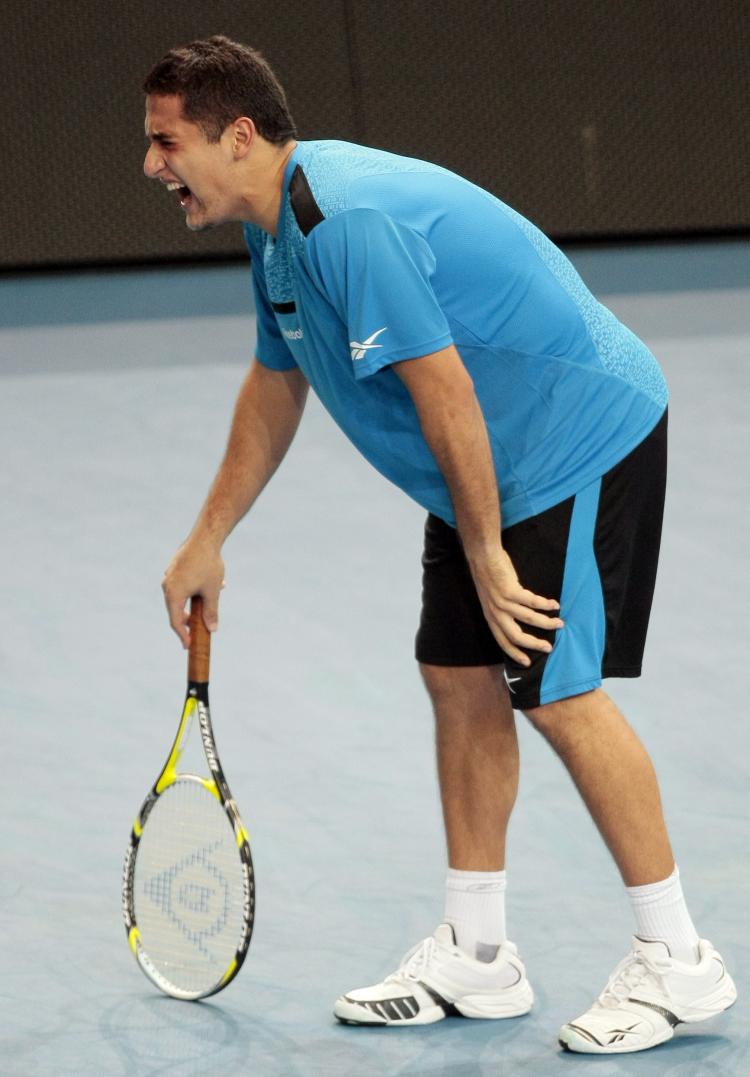 CRAMPS: Spain's Nicolas Almagro starts cramping up in the third set against Rafael Nadal. (JACQUES DEMARTHON/AFP/Getty Images)