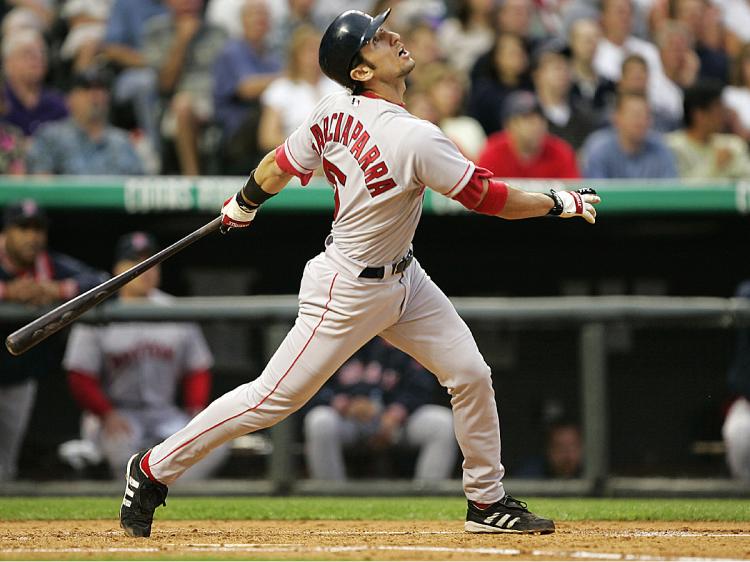 Nomar Garciaparra, in one of his last games with the Boston Red Sox, hits a sacrifice fly to right field with the bases loaded to score Mark Bellhorn against the Colorado Rockies, June 15, 2004. (Brian Bahr/Getty Images)