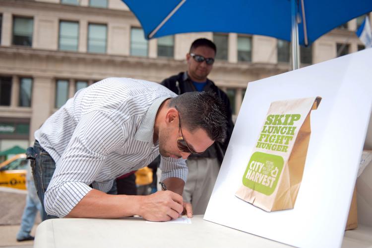 NY Mets center fielder Angel Pagan met with City Harvest and fans near the Flatiron building on Tuesday to help launch their new program to help raise funds to feed children facing hunger over the summer. Urging people to donate what they would spend on lunch, the program asks individuals to 'Skip Lunch Fight Hunger.' City Harvest feeds hungry New Yorkers by linking the food industry, various organizations, foundations, and private citizens. City Harvest helps to provide food to over 260,000 men, women, and children each week.  (Aloysio Santos/The Epoch Times)