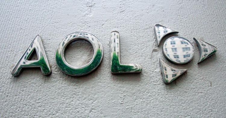 The AOL logo is displayed in front of its corporate headquarters on Broadway in New York City. As a part of its spinoff from parent Time Warner, AOL plans to lay off roughly one-third of its employees. (Mario Tama/Getty Images)