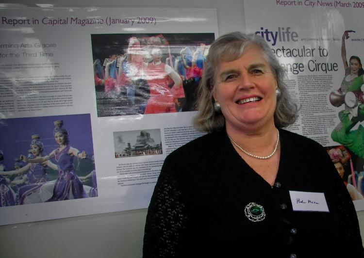 Local Canberra art critic Ms. Helen Musa standing in front of a wall with three of her previous reviews of the show (Steve Xu/The Epoch Times)