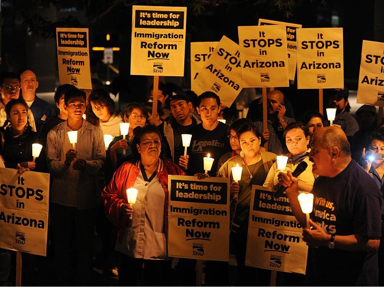 Mexican and Latino janitors hold a candlelight vigil calling for federal immigration reform, in response to the tough new Arizona law giving the police new stop and search powers, outside their workplaces in Los Angeles on May 20, 2010. (Mark Ralston/AFP/Getty Images)