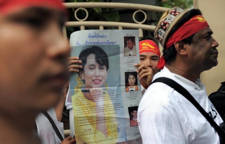 Political activists including exiles from Myanmar hold pictures of democracy icon Aung San Suu Kyi as they head towards the Myanmar embassy to stage a protest in Bangkok on November 7, 2010. (Christophe Archambault/AFP/Getty Images)