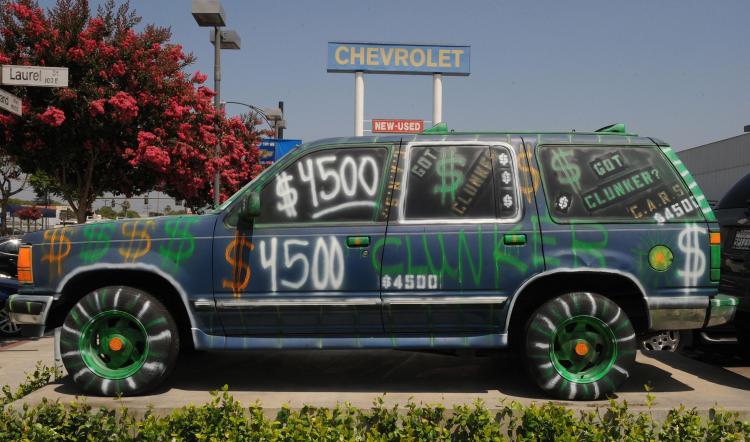 A car dealer uses a colorfully painted old car to promote its Cash for Clunkers sales promotion in Los Angeles. (Mark Ralston/AFP/Getty Images)