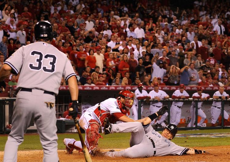 Hideki Matsui #55 of the New York Yankees slides into home base safe ahead of Jeff Mathis #5 of the Los Angeles Angels of Anaheim tag during the seventh inning in Game Five of the ALCS during the 2009 MLB Playoffs at Angel Stadium on October 22, 2009 in A (Kevork Djansezian/Getty Images)