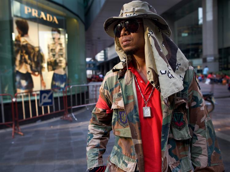 A protester stands guard next to a mall as thousands of Red shirt supporters of former PM Thaksin Shinawatra's occupy the streets of a busy shopping district forcing the closure of the malls April 3, 2010 in Bangkok,Thailand. (Paula Bronstein /Getty Images)