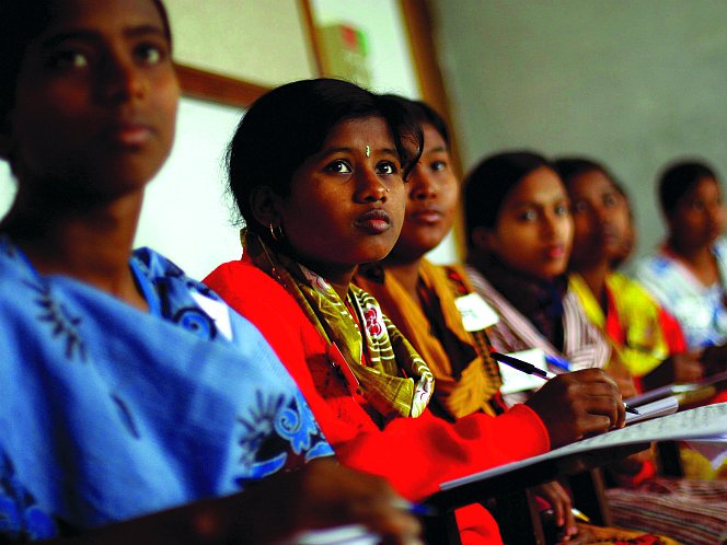 Women in Bangladesh attend a literacy class given at a BRAC support center. 