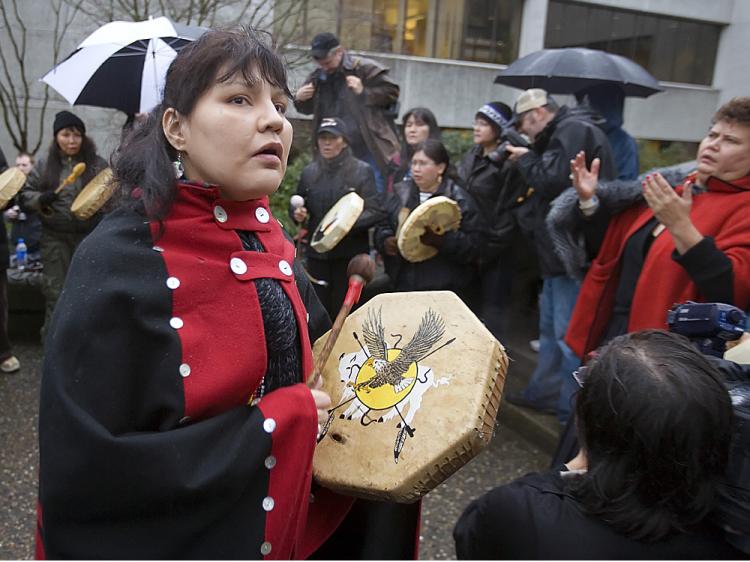 Natives drum and chant outside court in New Westminster, Canada, on the first day of the grisly murder trial of pig farmer Robert Pickton in January 2007.    (Jeff Vinnick/Getty Images)