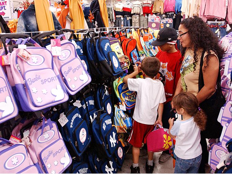 The Benevides family shops for school bags and back to school clothes at Cookies in the Brooklyn borough of New York City.    (Stephen Chernin/Getty Images )
