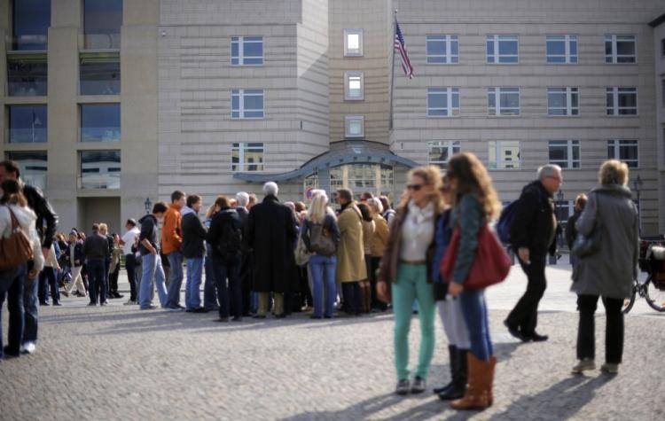 Tourists stand in front of the US embassy in Berlin. Britain and Japan issued on Monday travel alerts to continental Europe-bound travelers following the United States' statement on potential terrorist threats in European countries. (Barbara Sax/AFP/Getty Images)