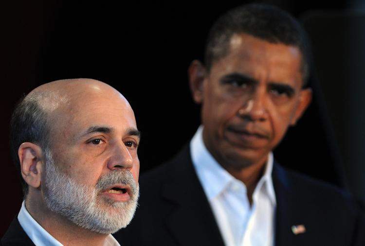 US President Barack Obama listens as Ben Bernanke speaks at the Oak Bluffs school on Martha's Vineyard, Massachusetts, on August 25, 2009. (Jewel Samad/AFP/Getty Images)