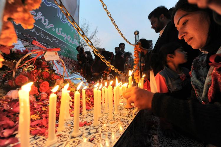 Supporters place lighted candles at the site where former Pakistani premier Benazir Bhutto was assassinated, on her first death anniversary in Rawalpindi on December 27, 2008. (Aamir Qureshi/AFP/Getty Images)