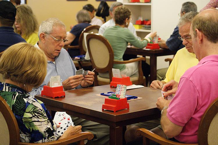 GOOD HAND? Players consider their cards during a duplicate match game hosted by the Manhattan Bridge Club on the Upper West Side in New York City on Tuesday. (Margaret Wollensak/The Epoch Times)