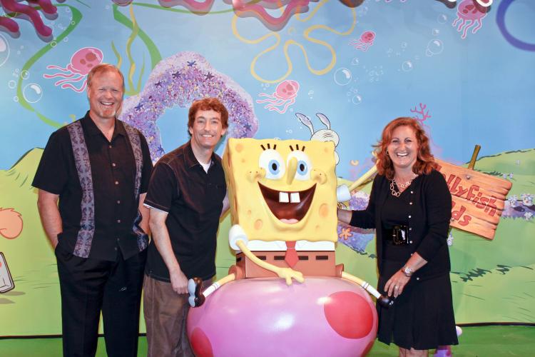 (R-L)Cyma Zarghami, Tom Kenny, and Bill Fagerbakke pose next to the newly erected SpongeBob Squarepants wax figure. (Cliff Jia/The Epoch Times)
