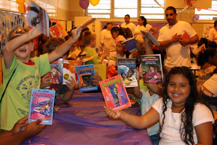 FREE READ: Children celebrate their new free books as a part of the Brooke Jackman Foundation's new Book in Hand initiative. 