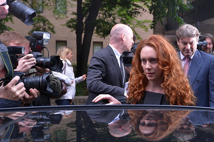 Rebekah Brooks, (2nd R) former chief executive of News International, and her husband Charlie Brooks (R) leave Southwark Crown Court in London, on June 22, after a preliminary hearing in which both face charges of conspiracy to pervert the course of justice in relation to the phone hacking scandal. (Carl Court/AFP/GettyImages)
