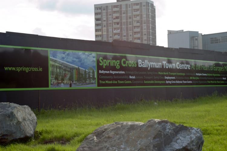 REGENERATION: The old Ballymun flats in north Dublin cast a shadow over a poster depicting a new vision for the region.  (Martin Murphy/The Epoch Times)