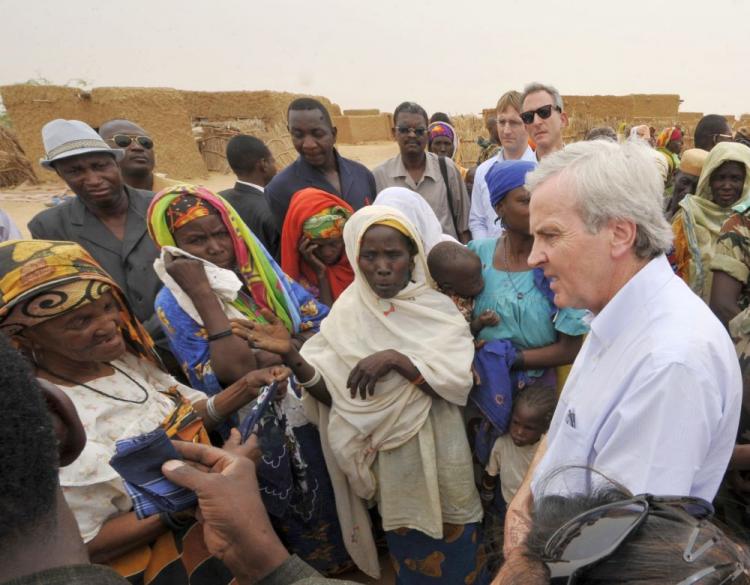 United Nations Under-Secretary-General for Humanitarian Affairs and Emergency Relief Coordinator John Holmes (R) speaks to women in the village of Daly in the region of Zinder on April 27. Holmes said Saturday that the U. N. estimates that 100 people were killed in February attack by the Lordâ��s Resistance Army LRA) in the DR Congo, bringing the estimated death toll in the area to over 500 since December.  (Sia Kambou/AFP/Getty Images )