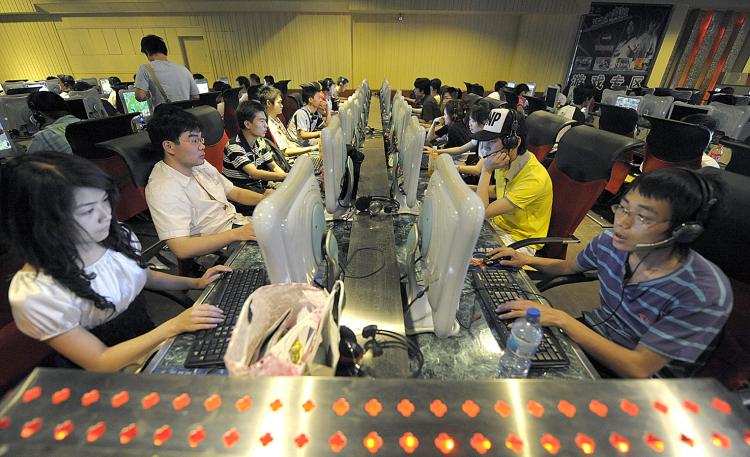People use computers at an Internet bar in Beijing. The Chinese regime is mandating censorship software for every computer sold in China. (Liu Jin/AFP/Getty Images)