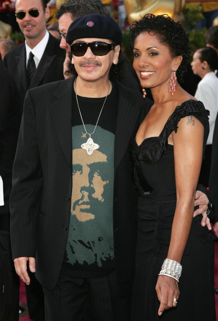 Sporting his Che Guevara T-shirt, musician Carlos Santana and his wife Deborah King Santana arrive at the 77th Annual Academy Awards in February 2005.  (Frank Micelotta/Getty Images)