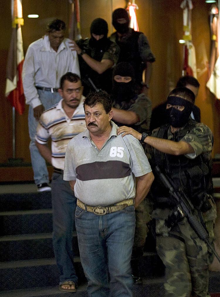 CARTEL ARRESTS: Ruben Granados (C) aka El Nene and two other members from drug cartel Beltran Leyva brothers are presented to the press at the General Attorney's office in Mexico City on April 14, 2009. Violence linked to the cartels claimed more than 5,3 (Fernan Castillo/AFP/Getty Images)