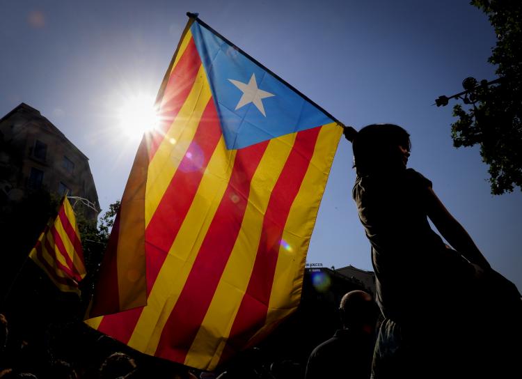 A woman holds the Catalan flag as hundreds of thousands of people marched on July 10 in Barcelona in support of the Catalan region's statute of autonomy. The statute, which was earlier approved by the Spanish Parliament and endorsed by Catalan voters in a 2006 referendum. (JOSEP LAGO/Getty Images ) A woman holds the Catalan flag as hundreds of thousands of people marched on July 10 in Barcelona in support of the Catalan region's statute of autonomy. The statute, which was earlier approved by the Spanish Parliament and endorsed by Catalan voters in a 2006 referendum. (JOSEP LAGO/Getty Images )