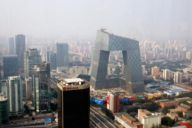 The new angled building of the state-run Chinese Central TV (CCTV) headquarters (centre) dominates the surrounding area in Beijing. (China Photos/Getty Images)