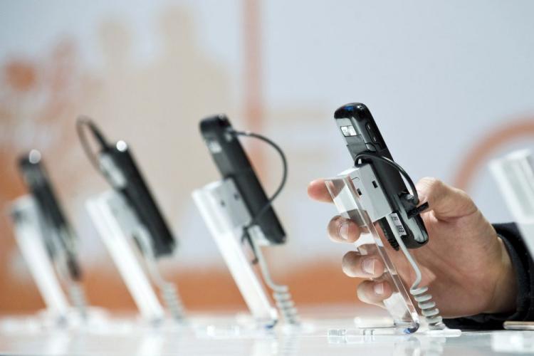 A row of cell phones at the world's biggest high-tech fair, the CeBIT on March 2 in the northern German city of Hanover. Companies are looking for new ways to charge the handheld phones. (Jens Schlueter/AFP/Getty Images)